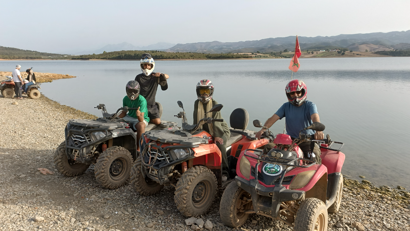 Family quad biking by a Moroccan lake